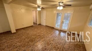 unfurnished room with ceiling fan and french doors