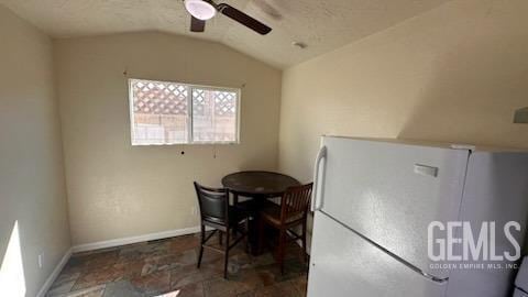 dining space featuring vaulted ceiling and ceiling fan