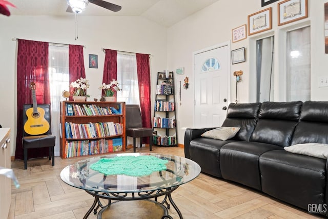 living room featuring vaulted ceiling, ceiling fan, and parquet flooring