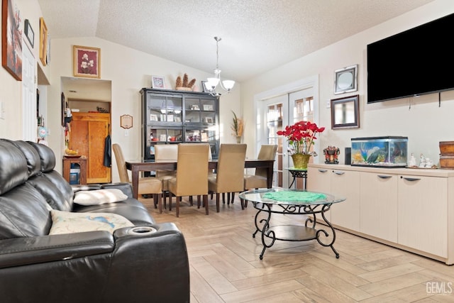 living room featuring a notable chandelier, vaulted ceiling, a textured ceiling, and light parquet floors