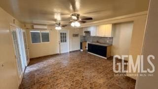 unfurnished living room with ceiling fan and an AC wall unit