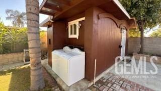 view of property exterior featuring separate washer and dryer