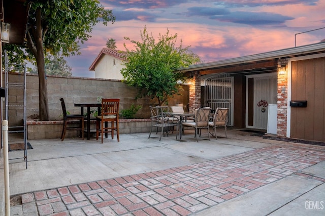 view of patio terrace at dusk