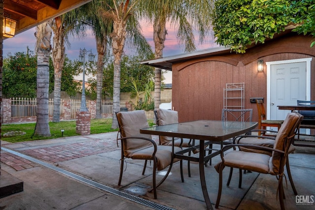 view of patio terrace at dusk