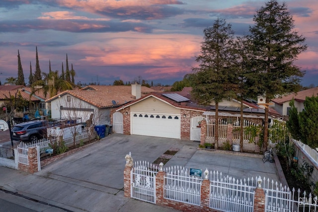 view of front of property with a garage and solar panels