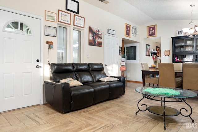 living room with a notable chandelier, lofted ceiling, a textured ceiling, and light parquet floors