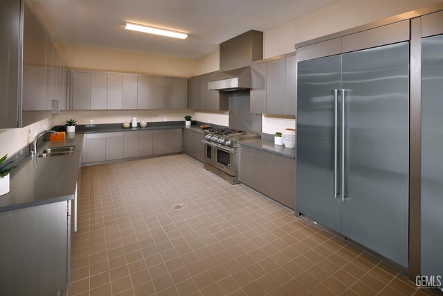 12800 Kinnick Ct, Bakersfield, CA 93311 - kitchen with high end appliances, dark countertops, light tile patterned floors, and gray cabinetry