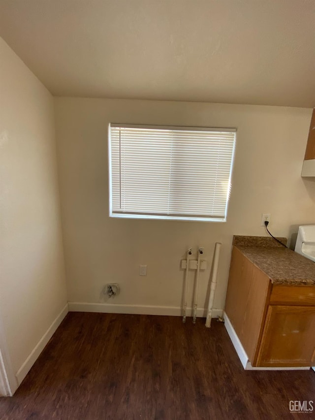 laundry area with dark hardwood / wood-style flooring, hookup for a washing machine, and cabinets