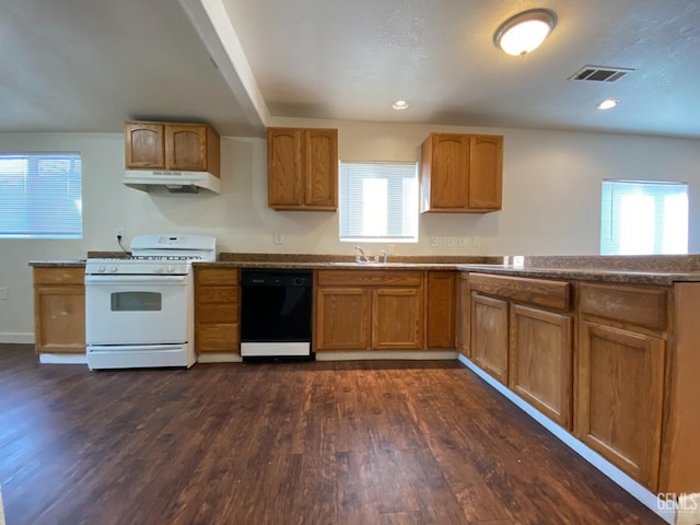 kitchen with plenty of natural light, black dishwasher, dark hardwood / wood-style floors, and white gas range oven