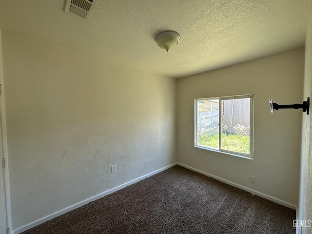 carpeted spare room featuring a textured ceiling