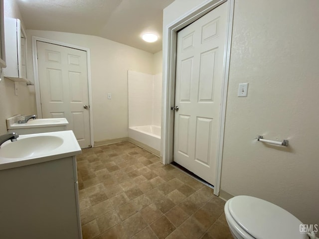 full bathroom featuring bathtub / shower combination, vanity, toilet, and vaulted ceiling