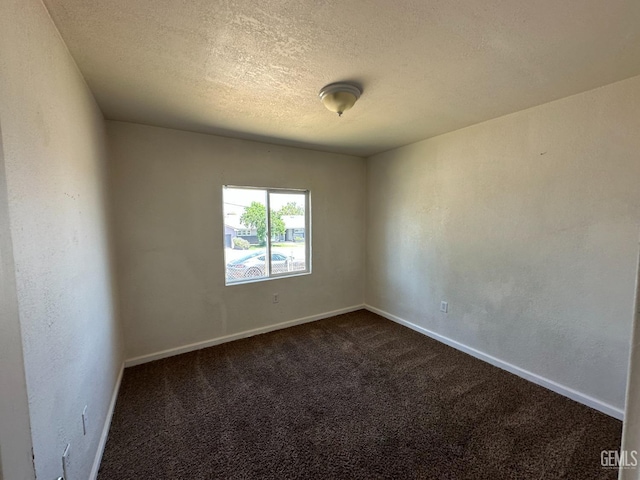 carpeted spare room featuring a textured ceiling