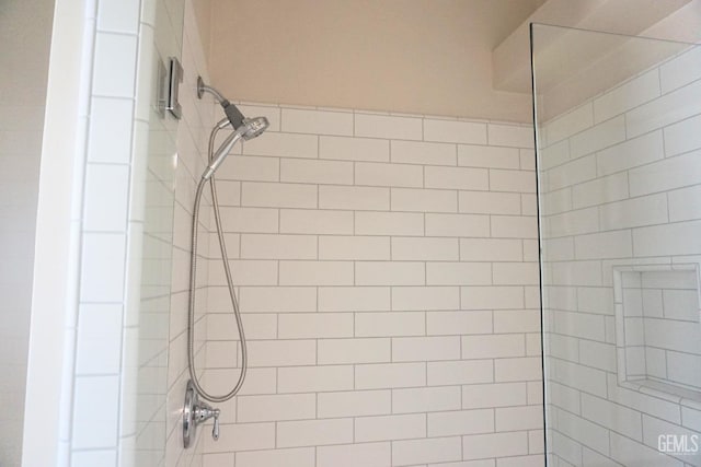 bathroom with tiled shower