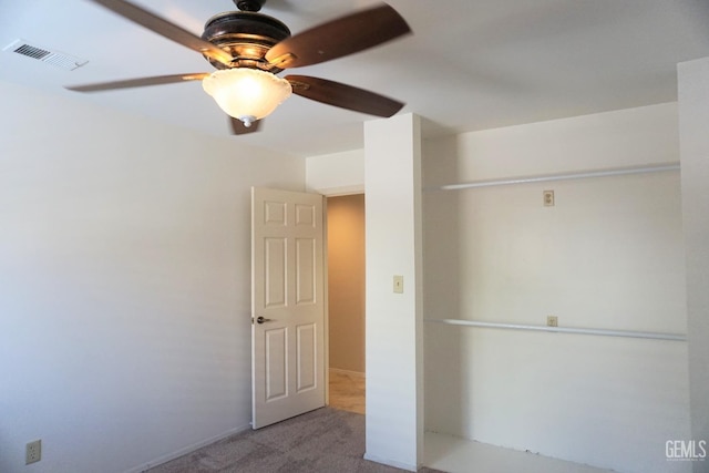 unfurnished bedroom featuring carpet flooring, visible vents, and a ceiling fan