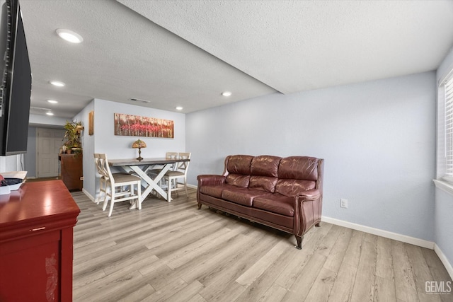 404 Colusa Ave, Chowchilla, CA 93610 - living room featuring light wood-style flooring, baseboards, a textured ceiling, and recessed lighting