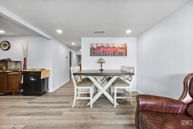 404 Colusa Ave, Chowchilla, CA 93610 - dining space with light wood-type flooring, a textured ceiling, recessed lighting, and baseboards