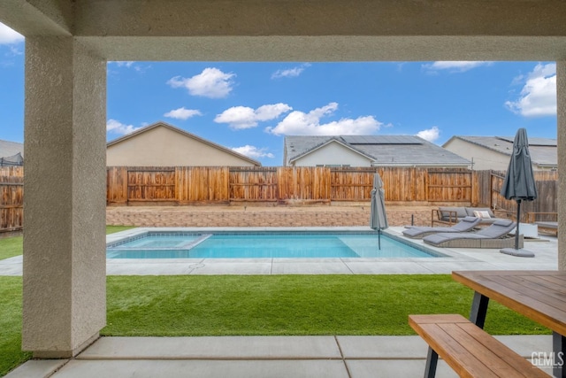 view of pool with a fenced backyard, a yard, a patio area, and a pool with connected hot tub