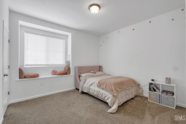 carpeted bedroom featuring baseboards