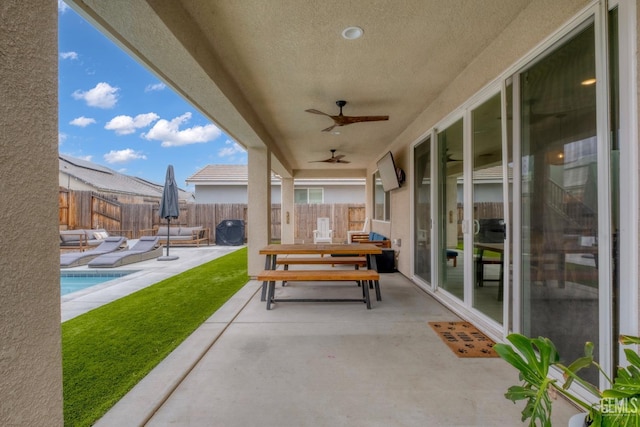 view of patio featuring a fenced backyard, a ceiling fan, and a fenced in pool