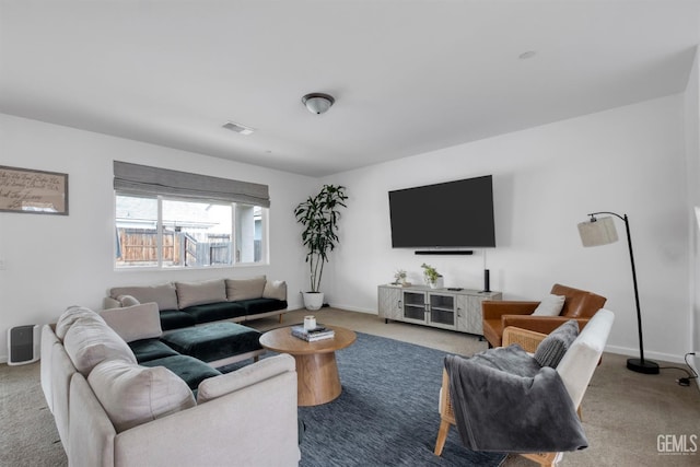 living room featuring baseboards, visible vents, and carpet