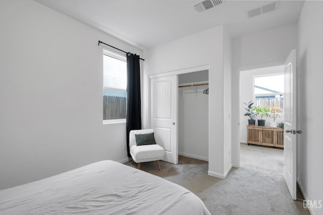 bedroom with baseboards, visible vents, carpet flooring, and radiator