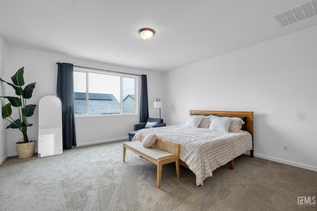 bedroom featuring carpet floors, visible vents, and baseboards