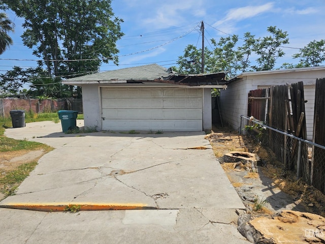 detached garage featuring fence