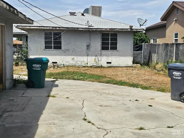 rear view of property with a patio, roof with shingles, fence, and crawl space
