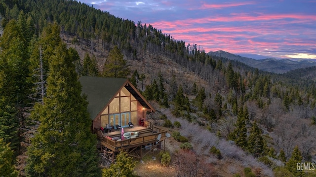 exterior space featuring a forest view and a mountain view