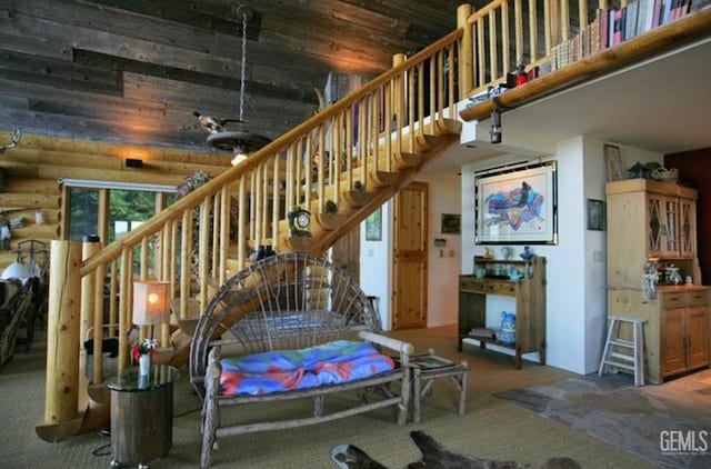 interior space featuring rustic walls, a towering ceiling, and carpet floors