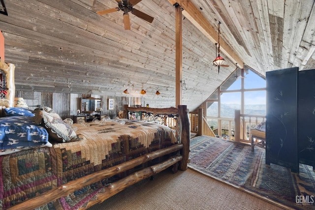 bedroom with a mountain view, wood ceiling, wooden walls, and lofted ceiling