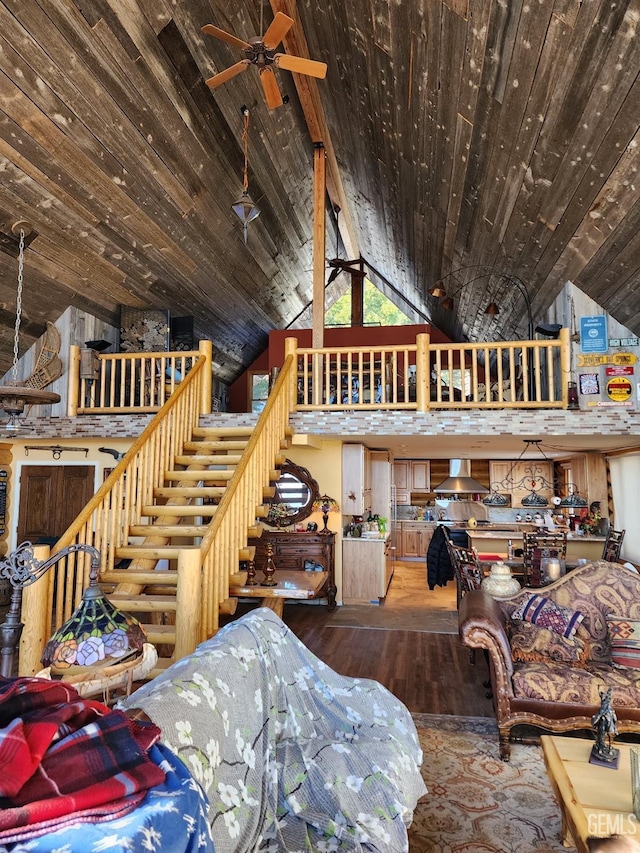 living area with high vaulted ceiling, wood ceiling, ceiling fan, and wood finished floors