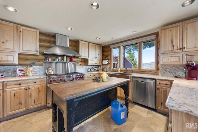 kitchen featuring a sink, wall chimney range hood, light brown cabinetry, and stainless steel appliances