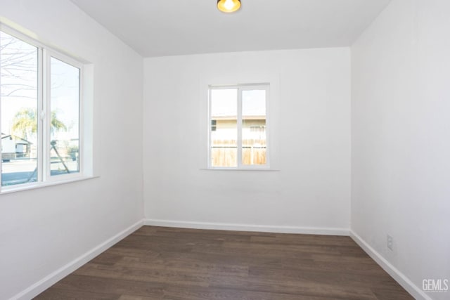 spare room featuring dark hardwood / wood-style flooring