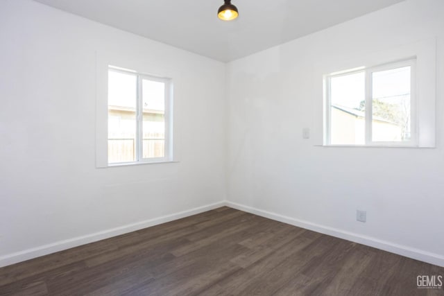 spare room with dark hardwood / wood-style flooring