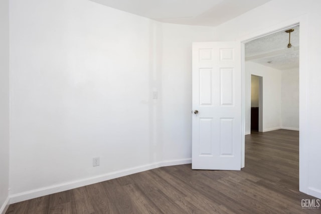 spare room featuring dark hardwood / wood-style flooring