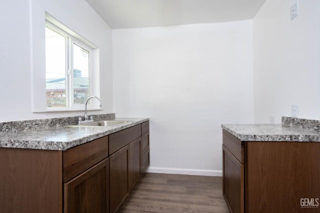 kitchen featuring dark hardwood / wood-style floors, sink, and dark brown cabinets