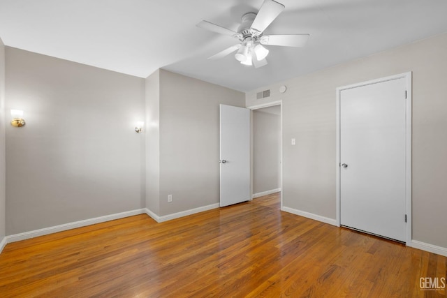 2613 Spruce St, Bakersfield, CA 93301 - unfurnished bedroom with wood finished floors, baseboards, and a ceiling fan
