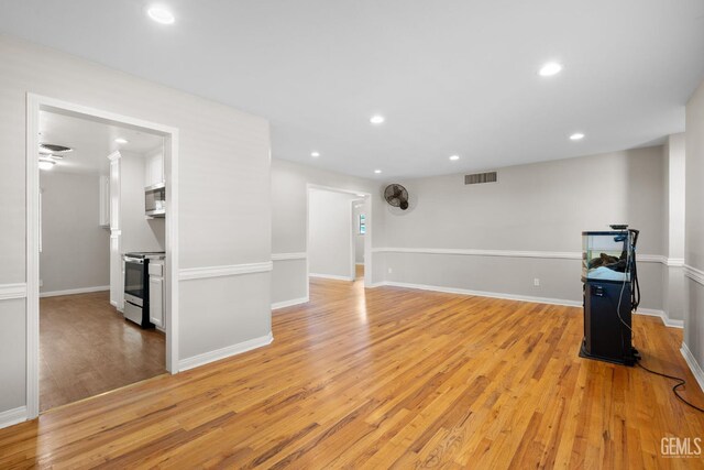 2613 Spruce St, Bakersfield, CA 93301 - unfurnished living room with light wood-style floors, recessed lighting, and baseboards