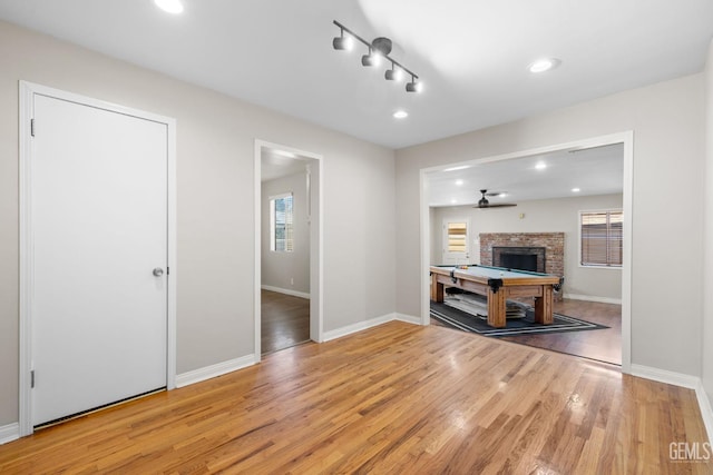 2613 Spruce St, Bakersfield, CA 93301 - living room featuring wood finished floors, baseboards, billiards table, a fireplace, and recessed lighting