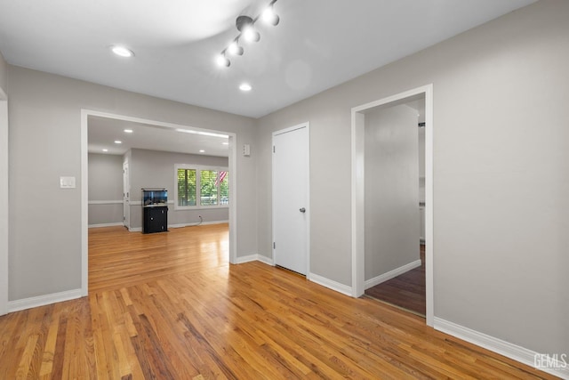 2613 Spruce St, Bakersfield, CA 93301 - unfurnished living room featuring light wood finished floors, baseboards, and recessed lighting