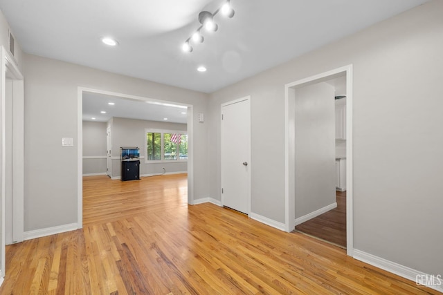 2613 Spruce St, Bakersfield, CA 93301 - unfurnished living room with light wood-type flooring, baseboards, and recessed lighting