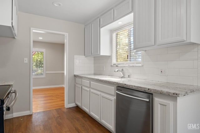 2613 Spruce St, Bakersfield, CA 93301 - kitchen featuring appliances with stainless steel finishes, a sink, dark wood-style floors, baseboards, and tasteful backsplash