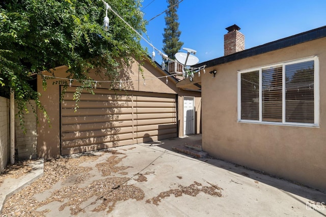 2613 Spruce St, Bakersfield, CA 93301 - view of patio featuring fence and a garage
