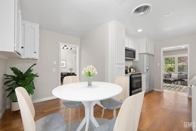 2613 Spruce St, Bakersfield, CA 93301 - dining room with baseboards, wood finished floors, and recessed lighting