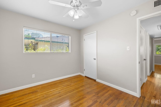 2613 Spruce St, Bakersfield, CA 93301 - unfurnished bedroom with light wood-style floors, baseboards, a ceiling fan, and a closet