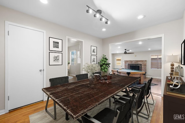 2613 Spruce St, Bakersfield, CA 93301 - dining area featuring light wood-style flooring, a brick fireplace, recessed lighting, and baseboards