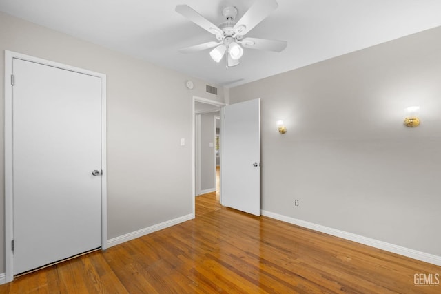 2613 Spruce St, Bakersfield, CA 93301 - unfurnished bedroom featuring baseboards, wood finished floors, and ceiling fan