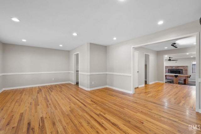 2613 Spruce St, Bakersfield, CA 93301 - unfurnished living room with light wood-style floors, baseboards, a fireplace, recessed lighting, and a ceiling fan