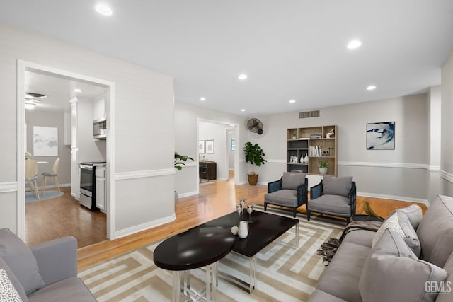 2613 Spruce St, Bakersfield, CA 93301 - living area featuring wood finished floors, recessed lighting, and baseboards